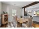 Cozy dining room with a rustic wooden table, wicker chairs, and view to adjacent kitchen at 3348 River Landing Rd, Johns Island, SC 29455