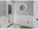 Sunlit entryway featuring a decorative mirror, wainscoting, and a glass door leading to a porch at 3348 River Landing Rd, Johns Island, SC 29455