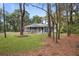Charming home with a front porch, gray siding, white trim, and a lush green lawn surrounded by trees at 3348 River Landing Rd, Johns Island, SC 29455