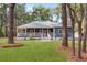 Charming single-story home with a classic porch and beautifully landscaped front yard at 3348 River Landing Rd, Johns Island, SC 29455