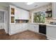 Well-lit kitchen with white cabinets, sleek countertops, and a view to the outside at 3348 River Landing Rd, Johns Island, SC 29455