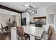Open kitchen with a marble island, stainless steel appliances, and dining area with unique wicker chairs at 3348 River Landing Rd, Johns Island, SC 29455