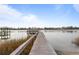 Picturesque waterfront view featuring a private wooden pier extending into the calm water at 3348 River Landing Rd, Johns Island, SC 29455
