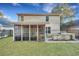 Exterior view of home with a screened porch, outdoor kitchen, and a green lawn at 3632 Locklear Ln, Mount Pleasant, SC 29466