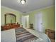 Bright bedroom with a large mirror dresser, complemented by soothing green walls and natural light at 3632 Locklear Ln, Mount Pleasant, SC 29466