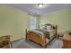 Cozy bedroom featuring soft green walls, a wooden bed frame, and warm, inviting decor at 3632 Locklear Ln, Mount Pleasant, SC 29466