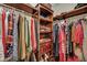Organized closet with wooden shelves and hanging rods, showcasing clothes and accessories at 3632 Locklear Ln, Mount Pleasant, SC 29466