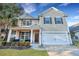 Charming two-story home with tan siding, attached garage, and inviting front porch at 3632 Locklear Ln, Mount Pleasant, SC 29466