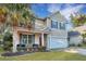 Charming two-story home with tan siding, attached garage, and inviting front porch at 3632 Locklear Ln, Mount Pleasant, SC 29466