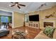 Bright living room featuring hardwood floors, fireplace, and a ceiling fan at 3632 Locklear Ln, Mount Pleasant, SC 29466