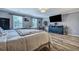Bright bedroom boasts hardwood-style floors, a mounted TV, and contemporary decor at 3632 Locklear Ln, Mount Pleasant, SC 29466