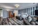 Spacious bedroom with a striped wall, ensuite bathroom, and hardwood-style flooring at 3632 Locklear Ln, Mount Pleasant, SC 29466