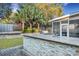 Outdoor kitchen features stone counter, grill, and access to the screened porch at 3632 Locklear Ln, Mount Pleasant, SC 29466