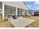 Screened in porch with a grill, table and chairs, and a concrete patio overlooking the lawn in the backyard at 376 Tupelo Lake Dr, Summerville, SC 29486