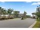 View of the community entrance with a covered gatehouse and beautiful landscaping leading into the neighborhood at 376 Tupelo Lake Dr, Summerville, SC 29486