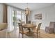 Bright dining room featuring modern light fixture, round table with seating for four, and sliding glass doors to patio at 376 Tupelo Lake Dr, Summerville, SC 29486