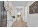 Inviting foyer with hardwood floors, a decorative mirror, and a glimpse into the living room at 376 Tupelo Lake Dr, Summerville, SC 29486