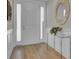 Bright foyer featuring a white door with sidelights, hardwood floors, and decorative accents for a welcoming entrance at 376 Tupelo Lake Dr, Summerville, SC 29486