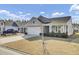 A beautiful single-story home with a two-car garage, a well-kept lawn, and a car parked in the driveway at 376 Tupelo Lake Dr, Summerville, SC 29486