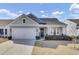 Charming single-story home with a well-manicured lawn, inviting front porch, and attached two-car garage at 376 Tupelo Lake Dr, Summerville, SC 29486