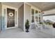 Inviting front porch with rocking chairs, decorative wreath, and stylish accents with a 'Welcome' sign at 376 Tupelo Lake Dr, Summerville, SC 29486