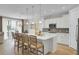 Open kitchen with white cabinets, a large center island with seating, and an adjacent dining area at 376 Tupelo Lake Dr, Summerville, SC 29486