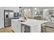 Bright kitchen with island, stainless steel appliances, modern cabinetry, and open sightlines to the living area at 376 Tupelo Lake Dr, Summerville, SC 29486