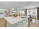 Open-concept kitchen featuring an island, stainless steel appliances, and views into the living and dining areas at 376 Tupelo Lake Dr, Summerville, SC 29486