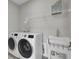 Functional laundry room with new washer, dryer, and utility sink at 376 Tupelo Lake Dr, Summerville, SC 29486
