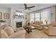 Comfortable living room with a fireplace, ceiling fan, and plenty of natural light at 376 Tupelo Lake Dr, Summerville, SC 29486