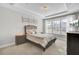 Bright main bedroom featuring tray ceilings, large windows, and neutral décor at 376 Tupelo Lake Dr, Summerville, SC 29486