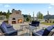 Inviting outdoor fireplace and seating area with lake view, perfect for relaxation and entertaining at 376 Tupelo Lake Dr, Summerville, SC 29486