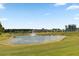 Beautiful community pond with water feature and community center in background at 376 Tupelo Lake Dr, Summerville, SC 29486