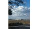 Scenic view of a marsh-front community with light-colored homes under a partly cloudy blue sky at 406 Patriot St, Sullivans Island, SC 29482