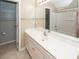 Bathroom features a single sink vanity, large mirror, and a view into the adjacent shower area at 5215 Chicory Ln, North Charleston, SC 29420