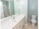 Bright bathroom with a long white vanity, large mirror, toilet, and a shower with glass door at 5215 Chicory Ln, North Charleston, SC 29420