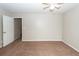 This bedroom includes neutral paint, carpeting, a ceiling fan and an entry door at 5215 Chicory Ln, North Charleston, SC 29420