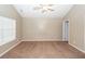A spacious bedroom features neutral paint, a ceiling fan, and a window letting in natural light at 5215 Chicory Ln, North Charleston, SC 29420
