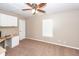 Bedroom with a ceiling fan, window, and built-in desk with cabinets for organized home office at 5215 Chicory Ln, North Charleston, SC 29420