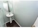 Simple, modern half bath with pedestal sink and wood-look floors at 5215 Chicory Ln, North Charleston, SC 29420
