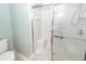 Clean, all-white shower with built-in seating and shelving behind a clear glass door at 5215 Chicory Ln, North Charleston, SC 29420
