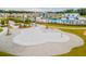 Aerial view of splash pad, playground, outdoor kitchen, pool, and green space in community at 708 Long Bluff Rd, Summerville, SC 29486