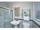Well-lit bathroom features tiled walls, glass shower door, and a pedestal sink at 715 Old Golf Rd, Summerville, SC 29483