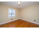 Bedroom with hardwood floors, a window, tan walls, and white trim at 715 Old Golf Rd, Summerville, SC 29483