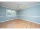Spacious bedroom with hardwood floors, a ceiling fan, and a large window at 715 Old Golf Rd, Summerville, SC 29483