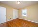 Empty bedroom with hardwood floors, closet, window, tan walls, and white trim at 715 Old Golf Rd, Summerville, SC 29483