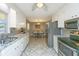 Well-lit kitchen featuring stainless steel appliances, granite countertops, and tile flooring at 715 Old Golf Rd, Summerville, SC 29483