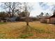 A large, fenced backyard, with a storage shed and trampoline, that offers plenty of space for outdoor activities and relaxation at 7645 Knollwood Dr, North Charleston, SC 29418