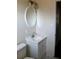 Bathroom featuring a white vanity, toilet, and an oval mirror with decorative lighting at 7645 Knollwood Dr, North Charleston, SC 29418