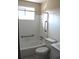Bathroom featuring a bathtub with white tile surround, grab bars and a window at 7645 Knollwood Dr, North Charleston, SC 29418